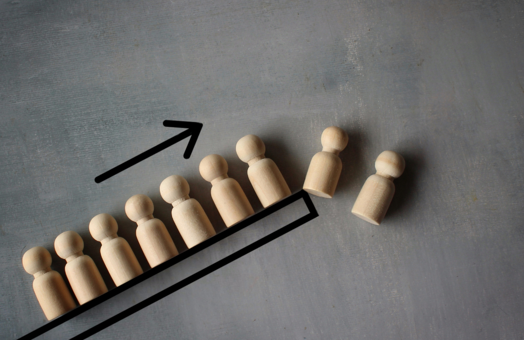 alt="wooden people representation with upward arrow"